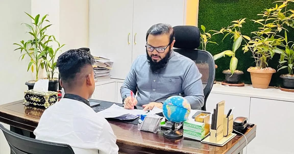 Consultant and applicant reviewing application documents together